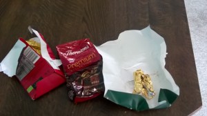 Several crumpled chocolate wrappers.